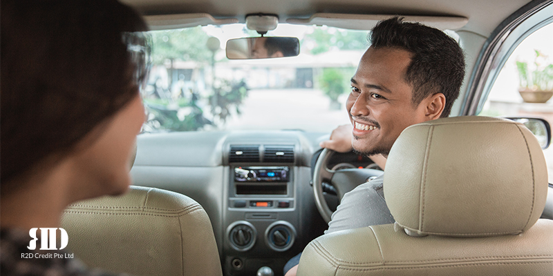 Grab or Gojek driver looking back and smiling at the passenger