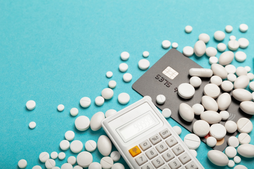 Credit card and medicines to illustrate the high cost of treatment in Singapore which can be avoided with medical loans